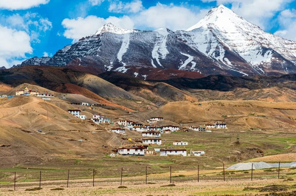 Picturesque village at the base of snow-capped mountains in Himachal Pradesh, India.