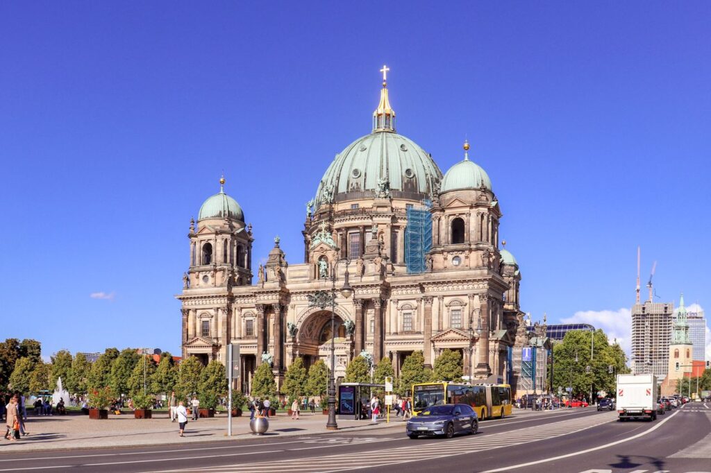 A stunning view of Berlin Cathedral captured on a sunny day, showcasing its architectural grandeur and bustling surroundings.